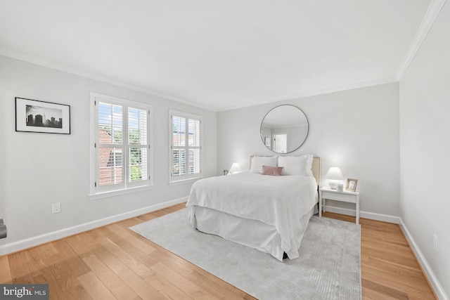 bedroom featuring light hardwood / wood-style floors and crown molding