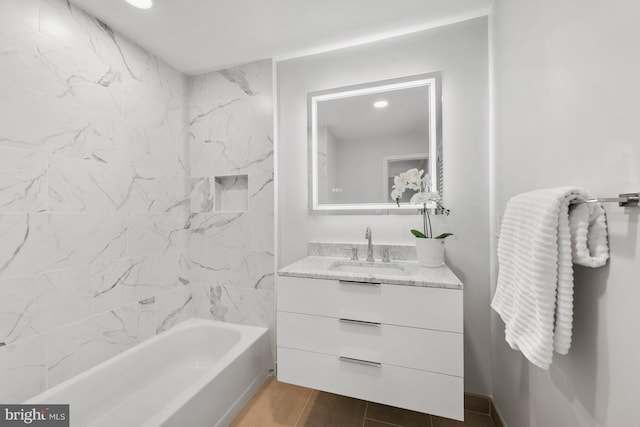 bathroom featuring vanity and tiled shower / bath combo