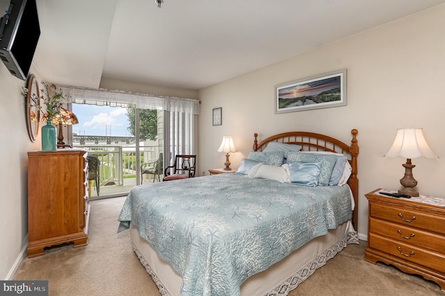 bedroom featuring access to exterior and light colored carpet