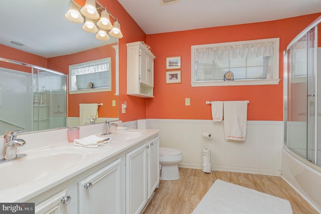 full bathroom with vanity, enclosed tub / shower combo, and toilet