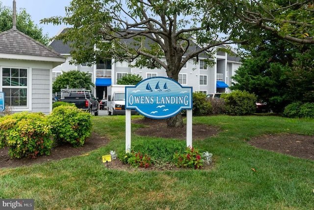 community / neighborhood sign with a lawn