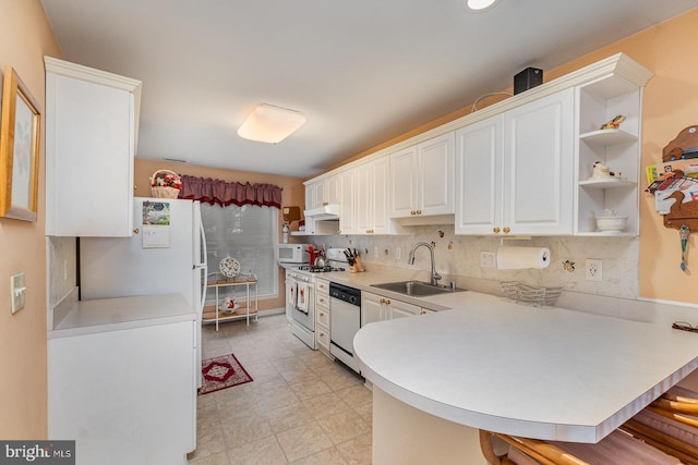 kitchen featuring kitchen peninsula, white cabinetry, sink, and white appliances