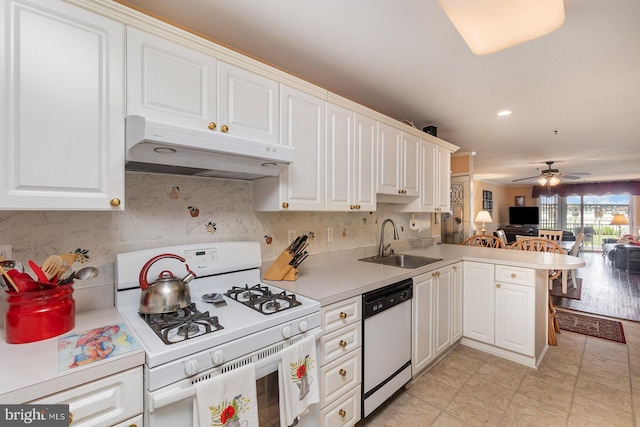 kitchen featuring ceiling fan, sink, kitchen peninsula, white appliances, and white cabinets