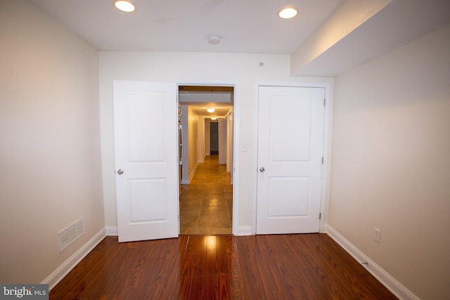 unfurnished bedroom with dark hardwood / wood-style floors