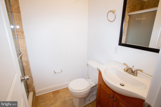 bathroom featuring vanity, toilet, and walk in shower