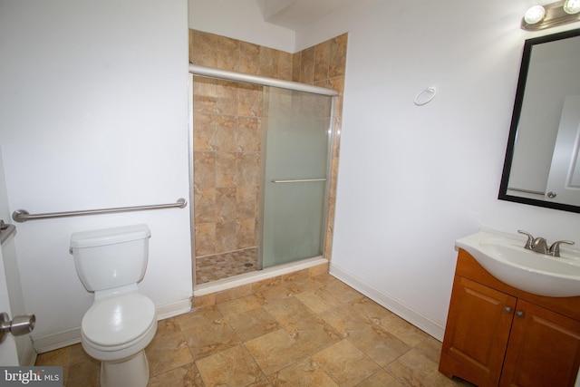 bathroom featuring vanity, toilet, and walk in shower