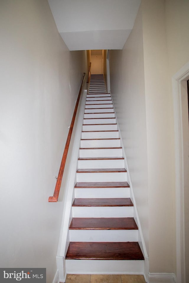 stairs featuring tile patterned flooring