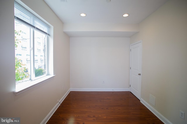 unfurnished room with dark hardwood / wood-style flooring