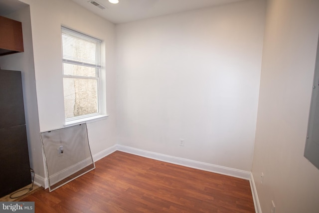 spare room with dark wood-type flooring