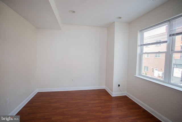 spare room featuring dark hardwood / wood-style flooring