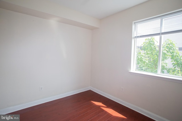 empty room featuring dark wood-type flooring