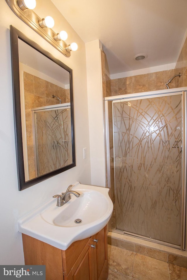 bathroom featuring vanity and an enclosed shower