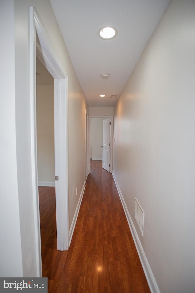 hall with dark hardwood / wood-style flooring