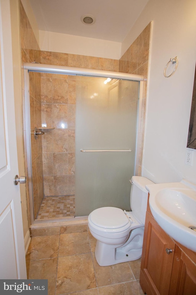 bathroom featuring vanity, toilet, and walk in shower