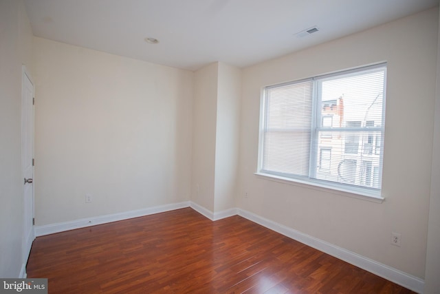 spare room with dark wood-type flooring