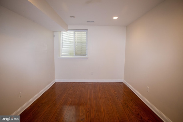 spare room with dark wood-type flooring