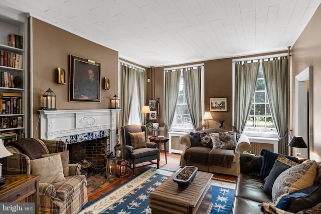 living room with hardwood / wood-style flooring and a fireplace