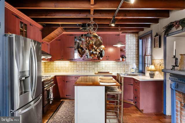 kitchen with backsplash, decorative light fixtures, stainless steel appliances, and wooden counters