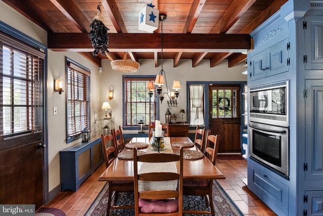 dining area with beamed ceiling, plenty of natural light, and wooden ceiling