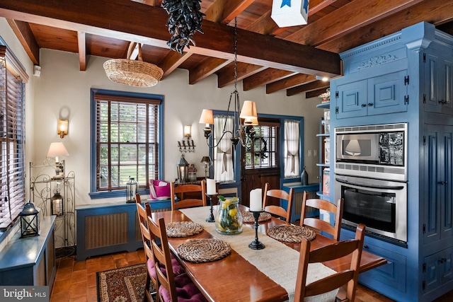 dining room with beam ceiling, wooden ceiling, and radiator