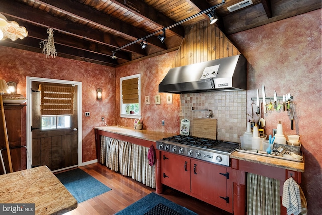 kitchen featuring wooden ceiling, dark wood-type flooring, wall chimney exhaust hood, and a healthy amount of sunlight