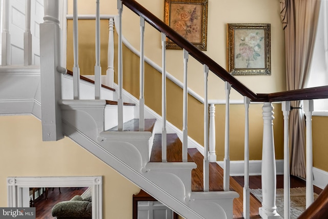 stairs with hardwood / wood-style flooring