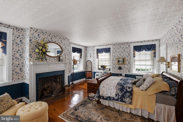 bedroom featuring wood-type flooring and a textured ceiling