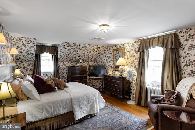 bedroom featuring hardwood / wood-style floors and radiator