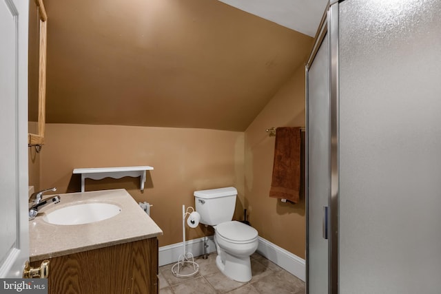 bathroom with toilet, vanity, tile patterned floors, and lofted ceiling