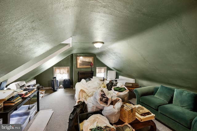 bedroom featuring carpet floors, a textured ceiling, and vaulted ceiling