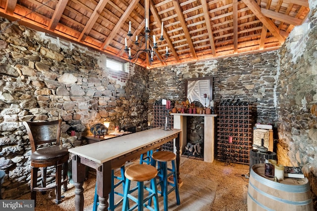 wine room with beamed ceiling, wooden ceiling, and high vaulted ceiling