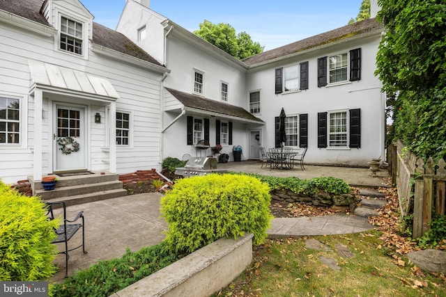 back of property with a patio