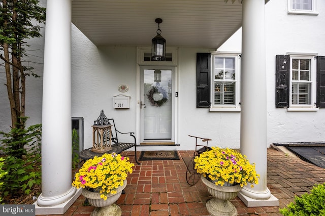 view of exterior entry featuring covered porch