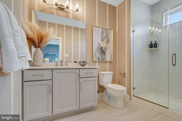 bathroom featuring vanity, toilet, and walk in shower