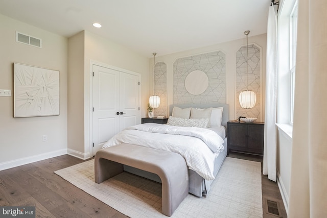 bedroom with a closet and dark hardwood / wood-style floors