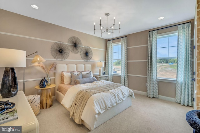 carpeted bedroom featuring built in desk and an inviting chandelier