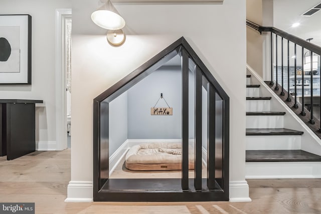 stairs with hardwood / wood-style floors