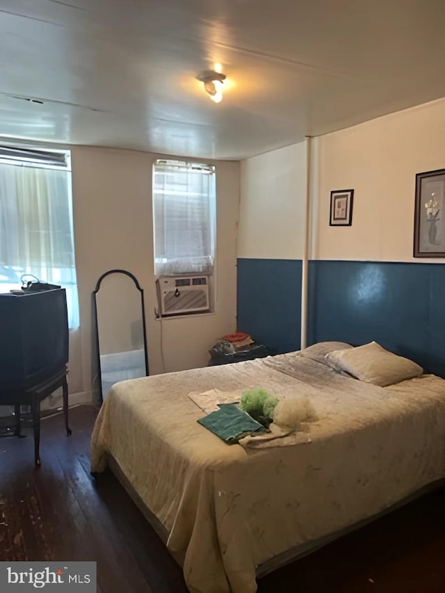 bedroom featuring cooling unit and dark wood-type flooring