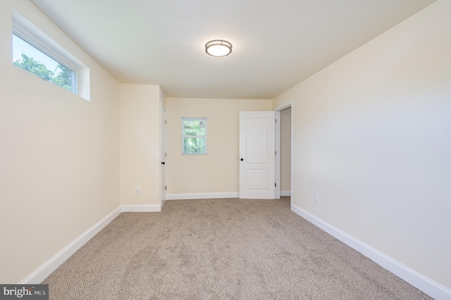 carpeted spare room featuring a healthy amount of sunlight