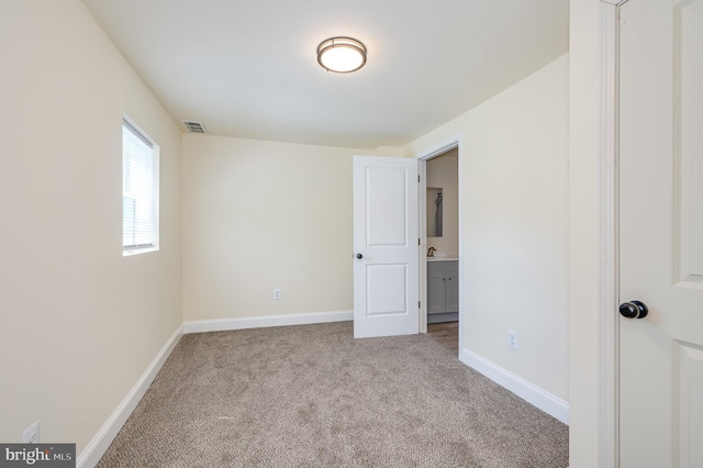 interior space featuring light colored carpet