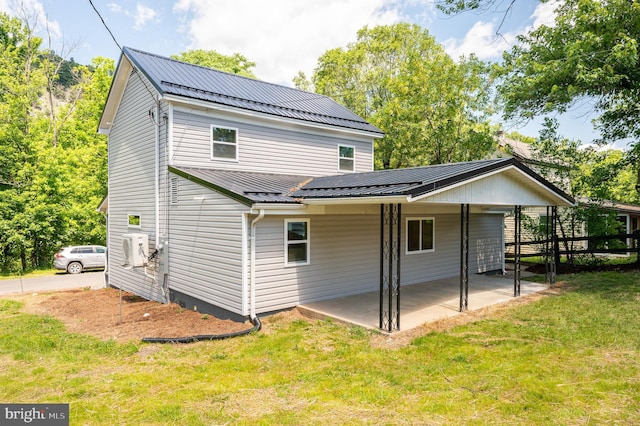 back of house featuring a lawn and a patio