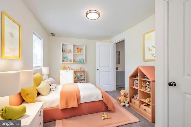 carpeted bedroom featuring connected bathroom