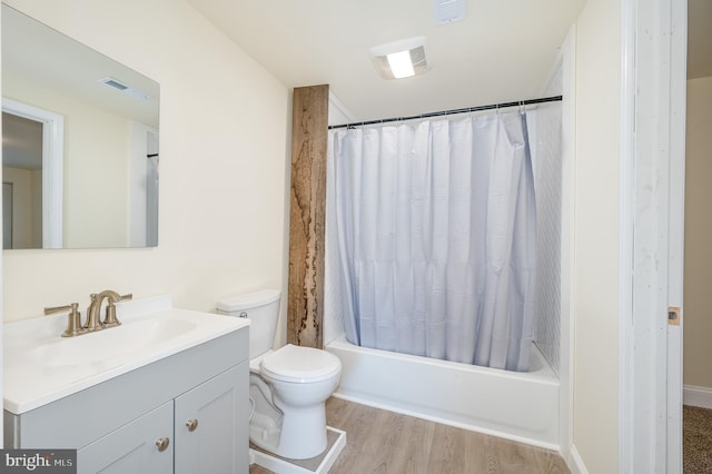 full bathroom featuring vanity, toilet, wood-type flooring, and shower / tub combo