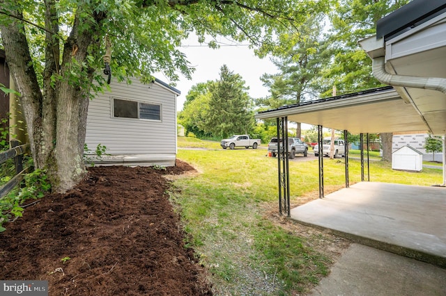 view of yard with a carport and a patio area