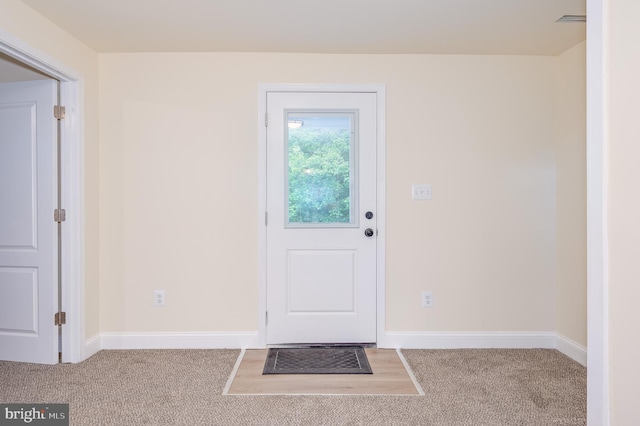 doorway with carpet floors