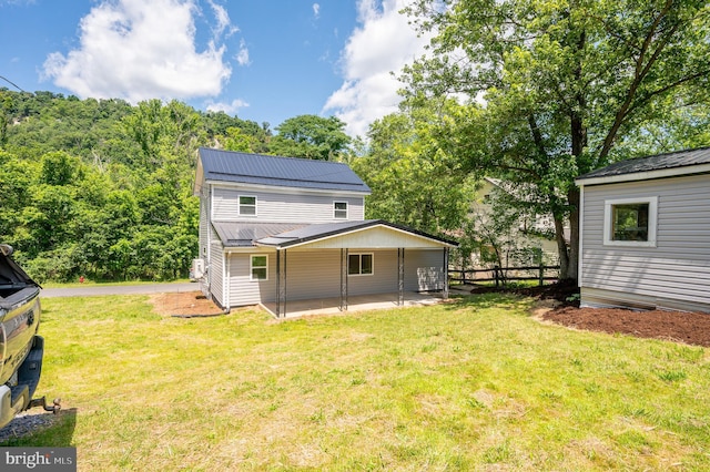 back of house featuring a patio area and a yard