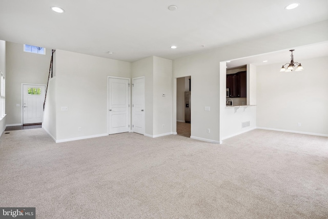 unfurnished living room featuring light carpet, baseboards, visible vents, and recessed lighting