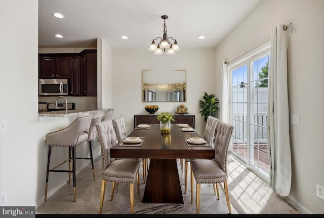 dining room with baseboards, a notable chandelier, and recessed lighting