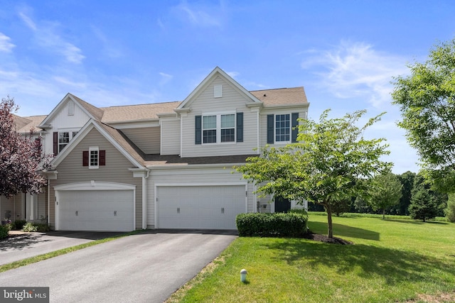 view of front facade with an attached garage, driveway, and a front yard