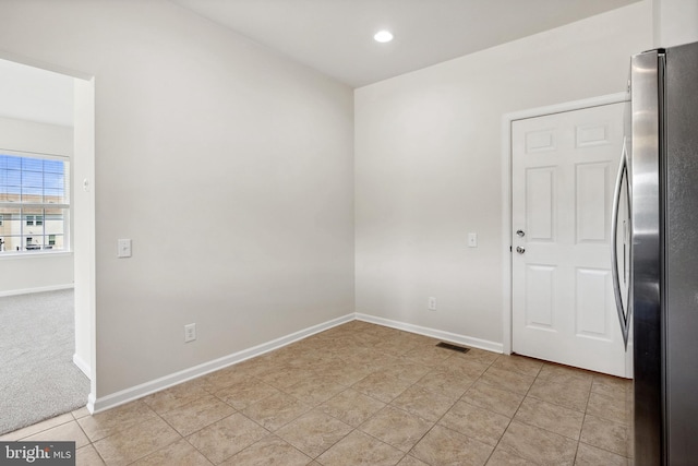 spare room featuring light tile patterned floors, recessed lighting, visible vents, and baseboards